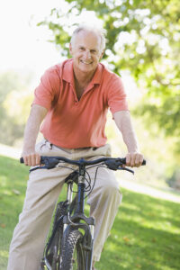 senior with hand arthritis riding a bike