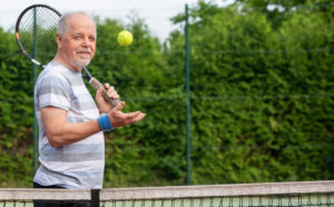 Older man playing tennis
