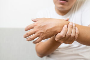 Man holding his painful wrist