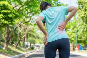 Young female runner experiencing back pain