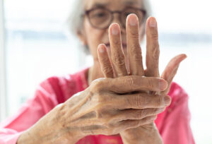 Mature woman massaging her painful hand