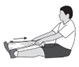 Man sitting on floor performing plantar fasciitis stretching exercises by pulling a towel wrapped around his feet